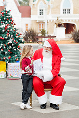 Image showing Girl Showing Wish List To Santa Claus