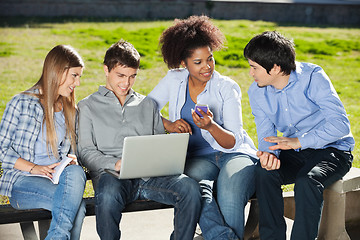 Image showing Students With Laptop And Mobilephone Sitting In Campus