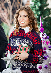 Image showing Woman Holding Christmas Present In Store