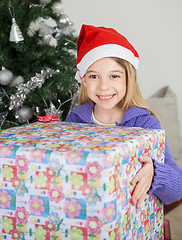 Image showing Girl Holding Gift By Christmas Tree