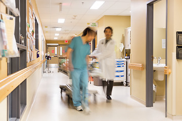 Image showing Doctor And Nurse Pulling Stretcher In Hospital Corridor