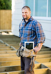 Image showing Worker With Digital Tablet And Hammer In Tool Belt At Site