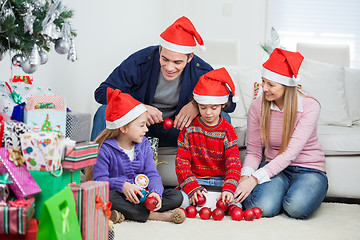 Image showing Family With Christmas Decorations And Gifts