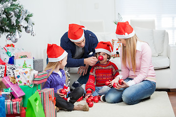 Image showing Family With Christmas Gifts And Ornaments