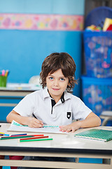 Image showing Boy With Sketch Pen Drawing In Classroom