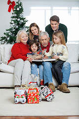 Image showing Family Looking At Book In House