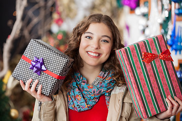 Image showing Woman Holding Christmas Presents In Store