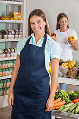 Image showing Saleswoman With Female Customer Shopping In Background