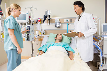 Image showing Doctor Discussing Medical Report With Nurse