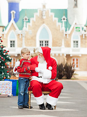 Image showing Boy Giving Letter To Santa Claus