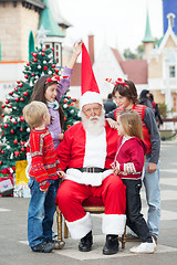 Image showing Children Playing With Santa Claus's Hat