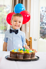 Image showing Happy Boy Sitting In Front Of Birthday Cake