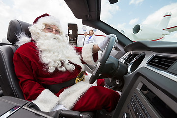 Image showing Santa Driving Convertible At Airport Terminal