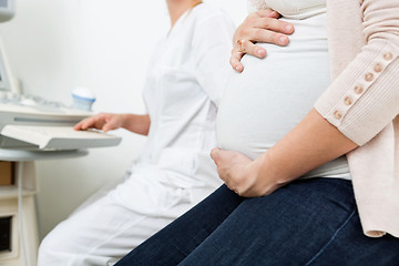 Image showing Pregnant Woman With Gynecologist In Background