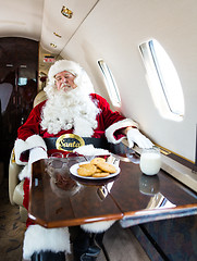 Image showing Santa With Eyes Closed Relaxing In Private Jet