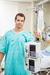 Image showing Patient Holding Pole With Drip Bag And Machine In Hospital