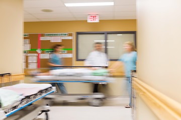 Image showing Doctor And Nurses With Stretcher In Hospital Corridor