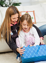 Image showing Mother And Girl Opening Christmas Present