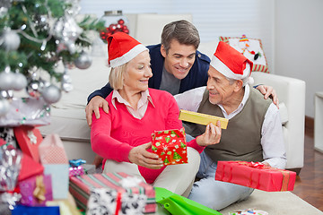 Image showing Happy Parents And Son With Christmas Presents