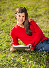 Image showing Woman With Books Relaxing On Grass At College Campus