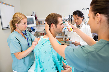 Image showing Medical Team Examining Male Patient