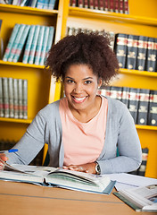 Image showing Female Student With Books Sitting At Table In Library