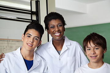 Image showing Teacher And Schoolboys Standing Together In Science Lab