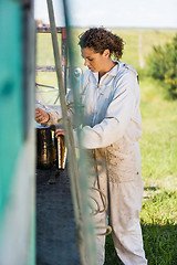 Image showing Beekeeper Preparing Smoker For Removing Honey