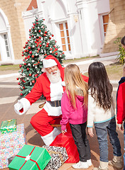 Image showing Santa Claus Gesturing While Looking At Girl