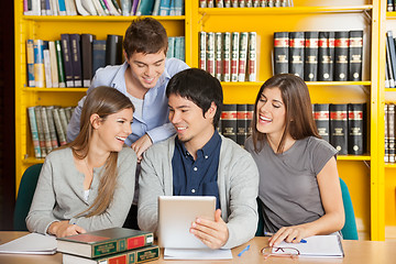 Image showing College Friends With Digital Tablet Studying In Library