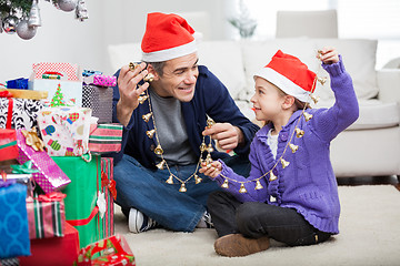 Image showing Father And Daughter Holding Christmas Ornaments