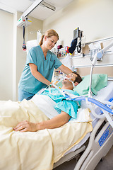 Image showing Nurse Adjusting Patient's Pillow