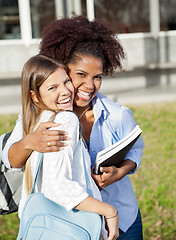 Image showing Loving Woman Embracing Friend On College Campus