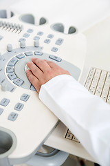 Image showing Gynecologist's Hand Using Ultrasound Machine
