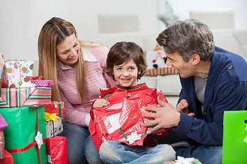 Image showing Boy And Parents Opening Christmas Present