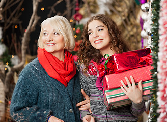 Image showing Mother And Daughter With Christmas Presents In Store