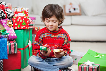 Image showing Boy Looking At Christmas Presents
