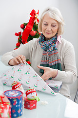 Image showing Woman Wrapping Christmas Present