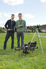 Image showing Engineers Holding Remote Controls Of UAV