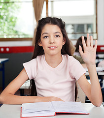 Image showing Schoolgirl Raising Hand In Classroom