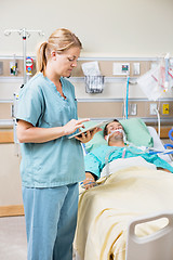 Image showing Nurse Using Digital Tablet While Patient Resting On Bed