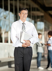 Image showing Professor With Book Standing On University Campus