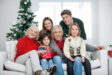Image showing Family With Christmas Present In House