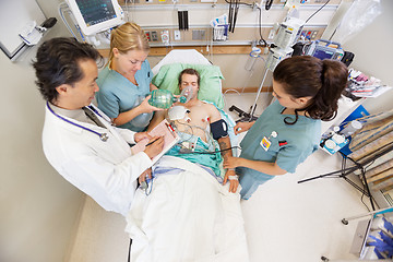 Image showing Doctor And Nurses Treating Critical Patient In Hospital