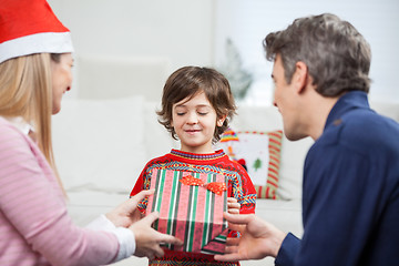 Image showing Parents Giving Christmas Present To Son