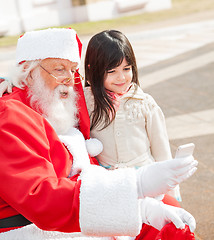 Image showing Girl And Santa Claus Taking Selfportrait Through Smartphone