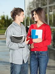 Image showing Students With Books Looking At Each Other On Campus