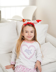 Image showing Cute Girl Wearing Santa Headband At Home