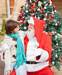 Image showing Boy Looking At Santa Claus In Front Of Christmas Tree