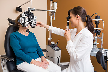 Image showing Optometrist Examining Senior Woman's Eyes